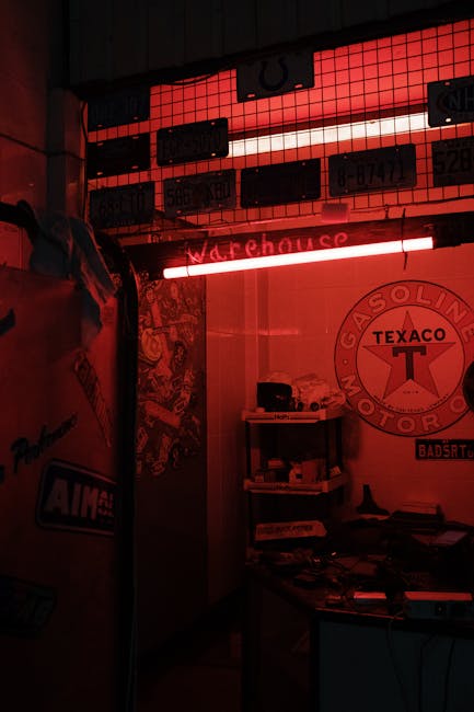 A garage interior featuring vintage decor and vibrant red neon lights.